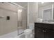 Clean bathroom with a walk-in shower, toilet and dark brown vanity at 2412 Dubai St, Kissimmee, FL 34747