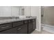 Modern bathroom with granite countertops, dark brown cabinets and a walk-in shower at 2412 Dubai St, Kissimmee, FL 34747
