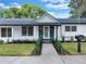 Ranch style home with modern exterior and landscaped lawn at 245 W George Ave, Maitland, FL 32751