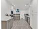 Modern kitchen with gray and white cabinets and a blue range hood at 245 W George Ave, Maitland, FL 32751