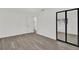 Bright bedroom with mirrored closet doors and wood-look flooring at 245 W George Ave, Maitland, FL 32751