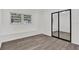 Spacious bedroom with wood-look flooring and mirrored closet doors at 245 W George Ave, Maitland, FL 32751