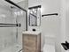 Updated bathroom with a large shower, wood vanity, and modern fixtures at 245 W George Ave, Maitland, FL 32751