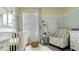 Bright Bedroom with crib, armchair, and neutral decor at 1010 Tupelo Trl, Haines City, FL 33844