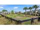 Fenced dog park with agility equipment and shaded areas for pets at 12152 Illustration Dr, Orlando, FL 32832