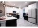 Modern kitchen with white and black cabinets and stainless steel appliances at 12152 Illustration Dr, Orlando, FL 32832