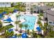 Community pool with surrounding lounge chairs and palm trees at 2610 Calistoga Ave, Kissimmee, FL 34741