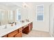 Clean bathroom with double vanity and large mirror at 2610 Calistoga Ave, Kissimmee, FL 34741
