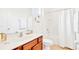 Clean bathroom with a shower/tub combo, wood vanity, and white linens at 2610 Calistoga Ave, Kissimmee, FL 34741