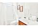 Clean bathroom with a tub, wood vanity, and framed art at 2610 Calistoga Ave, Kissimmee, FL 34741