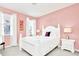 Charming bedroom with a white bed frame and soft pink walls at 2610 Calistoga Ave, Kissimmee, FL 34741