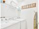 Laundry room with washer, dryer, shelving unit and an ironing board at 2610 Calistoga Ave, Kissimmee, FL 34741