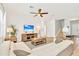 Living room with L-shaped sofa, coffee table, and large TV at 2610 Calistoga Ave, Kissimmee, FL 34741