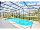 Relaxing kidney-shaped swimming pool with a screened enclosure at 2610 Calistoga Ave, Kissimmee, FL 34741