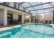 Inviting pool area with covered patio, seating, and dining areas at 2610 Calistoga Ave, Kissimmee, FL 34741