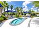 Community spa with seating and blue umbrellas at 2610 Calistoga Ave, Kissimmee, FL 34741