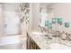 Double vanity bathroom with granite countertop and bathtub at 3475 Sandalwood Isle Way, Ocoee, FL 34761