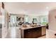 Island kitchen with granite countertops and stainless steel appliances at 3475 Sandalwood Isle Way, Ocoee, FL 34761