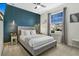 Main bedroom with a gray upholstered bed and a wall accent at 3894 Lana Ave, Davenport, FL 33897