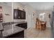 Kitchen boasts dark wood cabinets, granite countertops, and a view into the dining area at 4001 Scarlet Branch Rd, Orlando, FL 32824