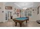 Game room features a pool table and eclectic wall decor at 4001 Scarlet Branch Rd, Orlando, FL 32824