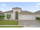 One-story house with a two-car garage, landscaping, and a paved driveway at 4001 Scarlet Branch Rd, Orlando, FL 32824