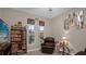 Cozy sitting room with a leather recliner, large TV and built-in shelving at 4001 Scarlet Branch Rd, Orlando, FL 32824