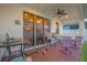 Covered patio with seating area and stained glass at 4001 Scarlet Branch Rd, Orlando, FL 32824
