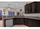 Kitchen with dark wood cabinets, granite counters, and stainless steel appliances at 4001 Scarlet Branch Rd, Orlando, FL 32824