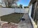 Landscaped backyard with grassy lawn and brick walkway at 6632 Meritmoor, Orlando, FL 32818