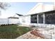 Backyard with patio, screen enclosure, and grassy area at 6632 Meritmoor, Orlando, FL 32818