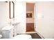 Bathroom with pedestal sink, toilet, and access to another room at 6632 Meritmoor, Orlando, FL 32818