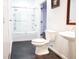 Clean bathroom with a shower/tub combo and dark tile floor at 6632 Meritmoor, Orlando, FL 32818