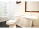 Clean bathroom with pedestal sink, shower/tub combo, and dark floor at 6632 Meritmoor, Orlando, FL 32818