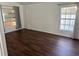 Bedroom with wood-look floors and two windows with curtains at 6632 Meritmoor, Orlando, FL 32818