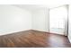 Simple bedroom with wood-look floors and large window at 6632 Meritmoor, Orlando, FL 32818