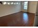 Well-lit bedroom featuring hardwood floors and a window at 6632 Meritmoor, Orlando, FL 32818