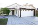 Front view of a single-story house with a two-car garage and landscaped yard at 6632 Meritmoor, Orlando, FL 32818