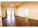 Spacious living room with wood-look floors and access to other rooms at 6632 Meritmoor, Orlando, FL 32818