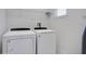 Laundry room with washer, dryer, and shelving at 7736 Graben St, Kissimmee, FL 34747