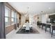 Elegant dining room with large table, modern chandelier, and access to kitchen at 7736 Graben St, Kissimmee, FL 34747