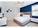 Bedroom with blue accent wall and gray upholstered bed at 7736 Graben St, Kissimmee, FL 34747