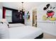 Mickey Mouse themed bedroom with two twin beds, en-suite bathroom, and TV at 7736 Graben St, Kissimmee, FL 34747