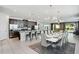 Open concept kitchen and dining area with large table and modern lighting at 7736 Graben St, Kissimmee, FL 34747