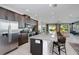 Modern kitchen with granite countertops, stainless steel appliances, and island at 7736 Graben St, Kissimmee, FL 34747