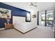 Bedroom with king-size bed, blue accent wall, and private access to patio at 7736 Graben St, Kissimmee, FL 34747