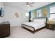 Spacious bedroom with king-size bed, accent wall, and plenty of natural light at 7736 Graben St, Kissimmee, FL 34747