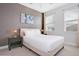 Guest bedroom with a queen bed and neutral color scheme at 7736 Graben St, Kissimmee, FL 34747