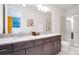 Double vanity bathroom with granite countertop and walk-in shower at 7736 Graben St, Kissimmee, FL 34747