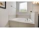Bathroom with soaking tub and modern fixtures at 7736 Graben St, Kissimmee, FL 34747